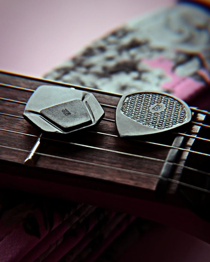 menu-06 Artistic shot of black guitar picks on electric guitar strings, ideal for music themes.